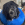 Um cachorro preto usando um anel KONG azul no pescoço.