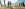 two people taking a golden retriever on a walk in the mountains